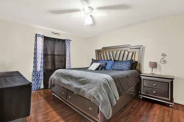 bedroom with ceiling fan, dark wood-type flooring, and a textured ceiling