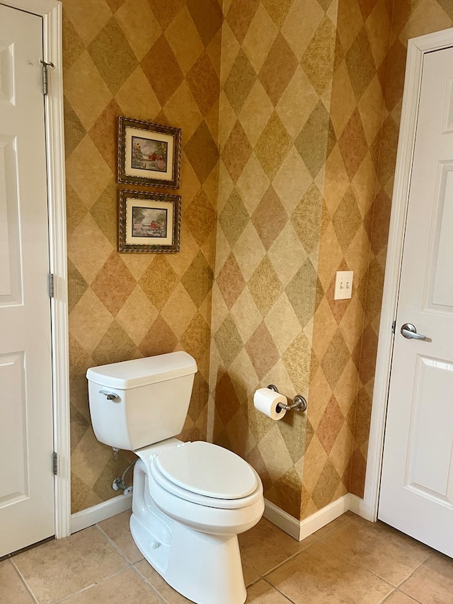bathroom featuring toilet and tile patterned flooring
