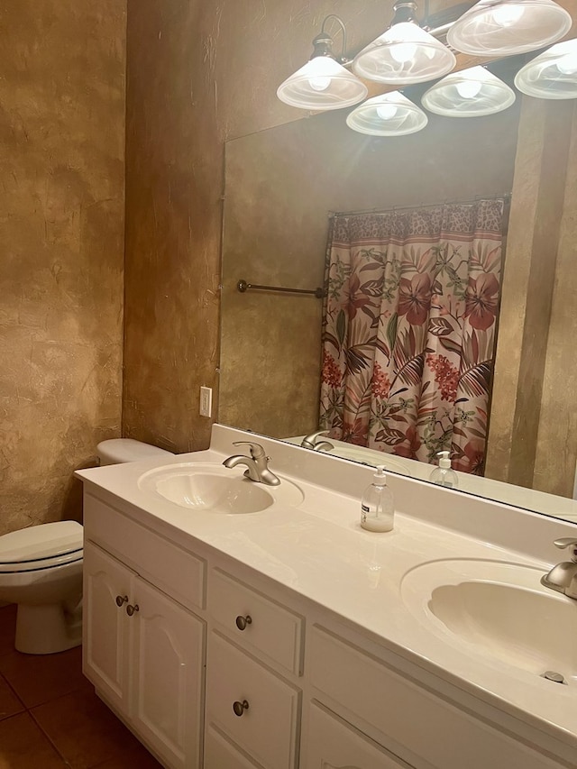 bathroom with vanity, toilet, and tile patterned flooring