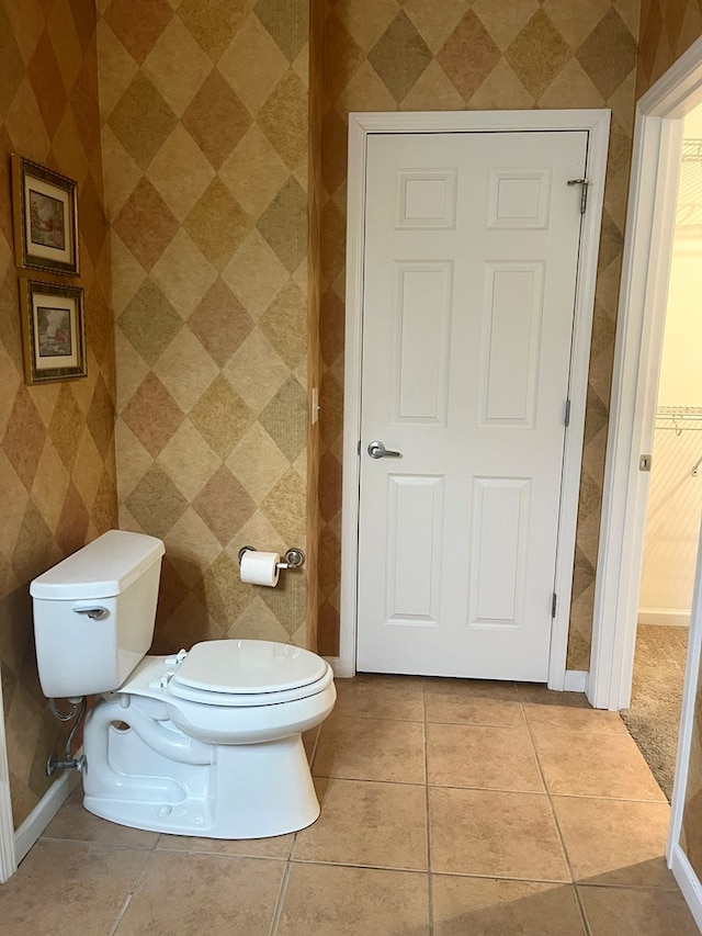 bathroom with tile patterned flooring and toilet