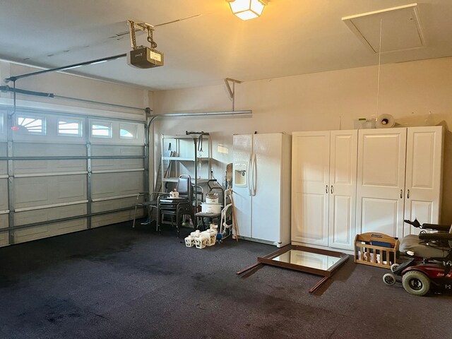 garage with a garage door opener and white refrigerator with ice dispenser