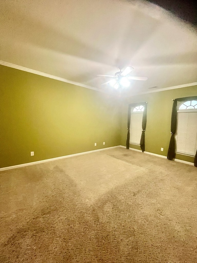unfurnished room featuring ornamental molding, ceiling fan, and carpet flooring