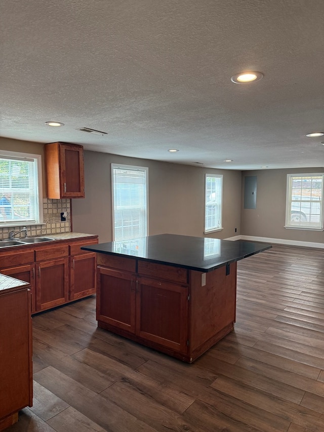 506 Teasley St, Dalton, GA 30721 - kitchen with a sink, dark wood-type flooring, recessed lighting, a textured ceiling, and a center island