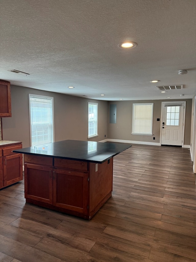 506 Teasley St, Dalton, GA 30721 - kitchen with dark countertops, dark wood finished floors, recessed lighting, a kitchen island, and a textured ceiling