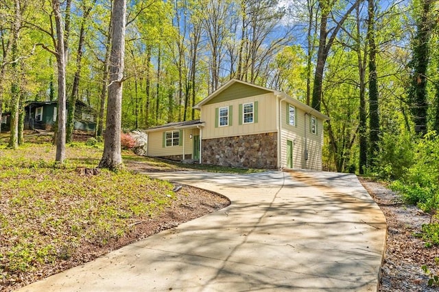 638 Pine Oaks Dr, Tunnel Hill, GA 30755 - split level home featuring stone siding, concrete driveway, and board and batten siding