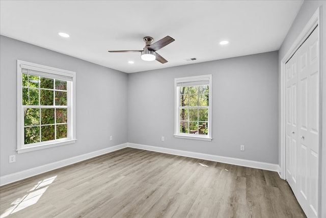 638 Pine Oaks Dr, Tunnel Hill, GA 30755 - unfurnished bedroom with a closet, multiple windows, wood finished floors, recessed lighting, and a ceiling fan
