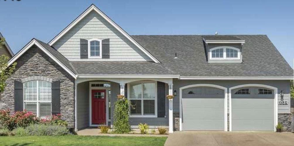 9 River Oaks Dr, Dalton, GA 30720 - view of front of property with stone siding, driveway, a shingled roof, and an attached garage