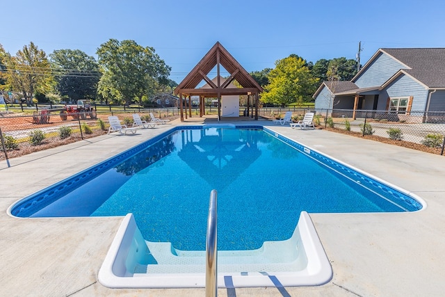 pool with a gazebo, a patio area, and fence