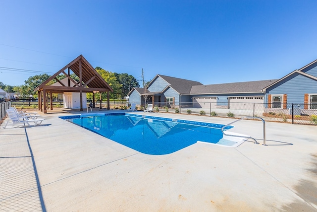 view of pool featuring a patio area, a fenced in pool, a gazebo, and fence
