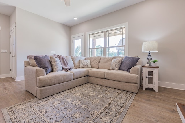 living room featuring ceiling fan, baseboards, wood finished floors, and recessed lighting