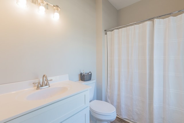 bathroom with a shower with shower curtain, toilet, and vanity