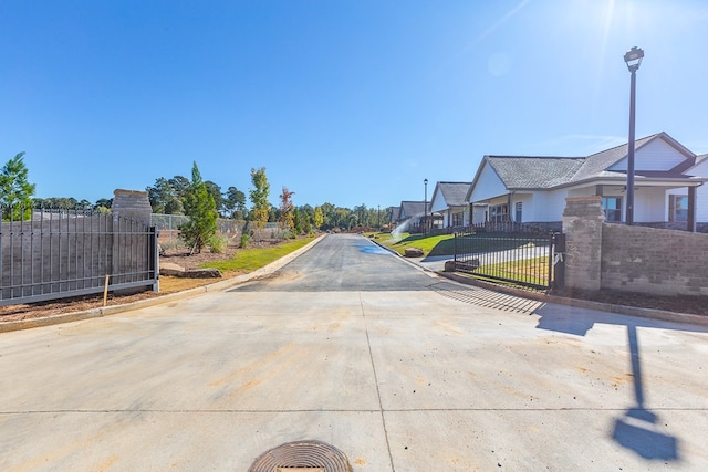 view of street featuring a residential view, curbs, and street lights