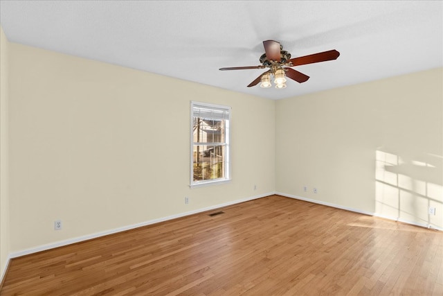 unfurnished room with ceiling fan, a textured ceiling, and light wood-type flooring