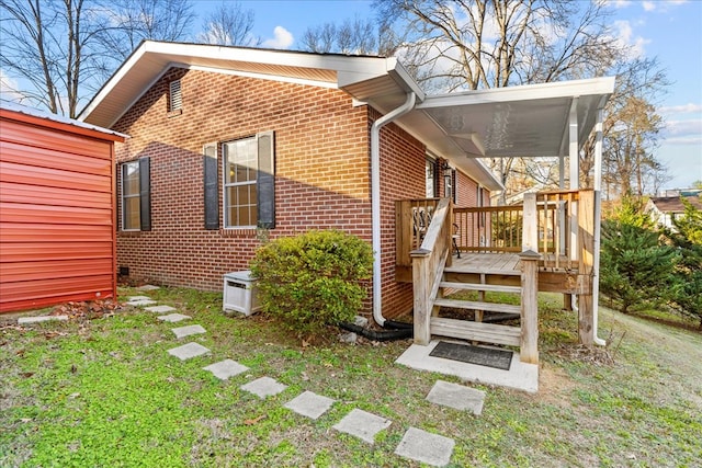 view of property exterior featuring a deck and a lawn