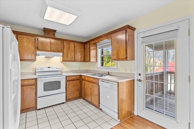 kitchen featuring white appliances and sink