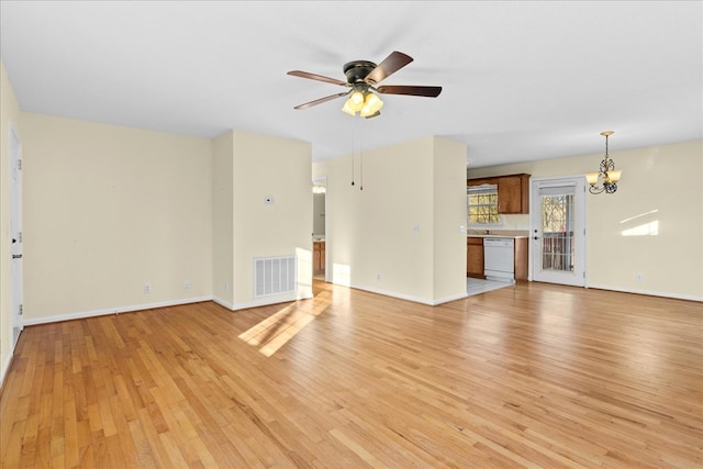 unfurnished living room with ceiling fan with notable chandelier and light wood-type flooring