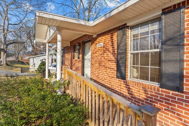 view of side of property with covered porch