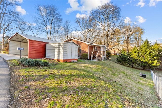 view of yard featuring a shed and a carport