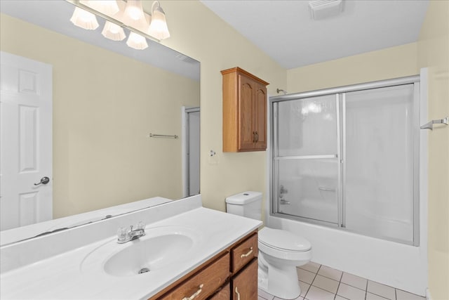 full bathroom featuring toilet, vanity, shower / bath combination with glass door, and tile patterned flooring