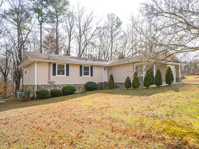 single story home featuring a garage, central AC unit, and a front lawn