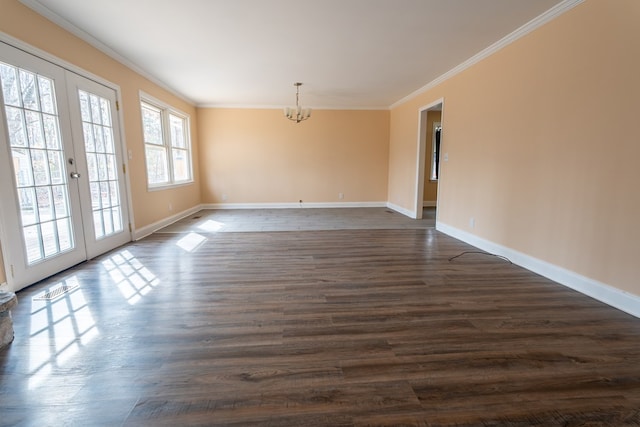 unfurnished room with crown molding, a notable chandelier, french doors, and dark wood-type flooring