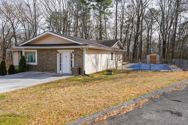 ranch-style house with stone siding, a front yard, and fence