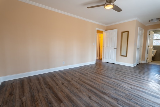 unfurnished bedroom with baseboards, ensuite bath, dark wood-style flooring, and crown molding