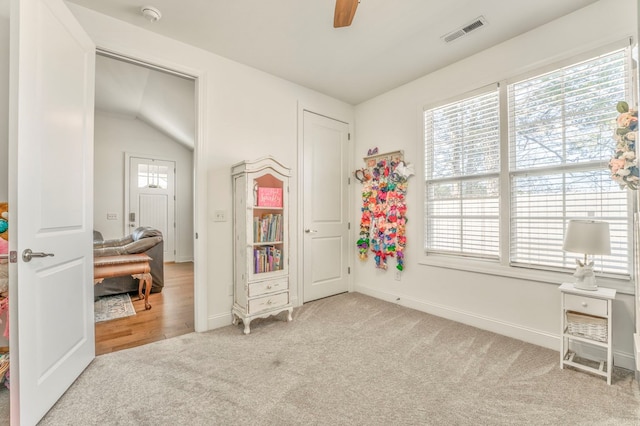 bedroom featuring ceiling fan and light carpet