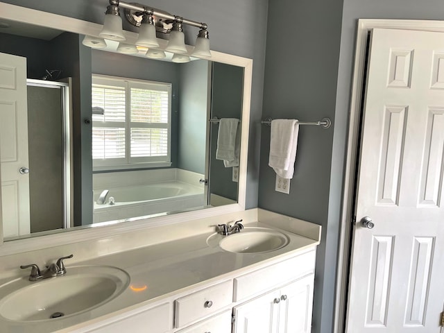 bathroom with shower with separate bathtub and vanity