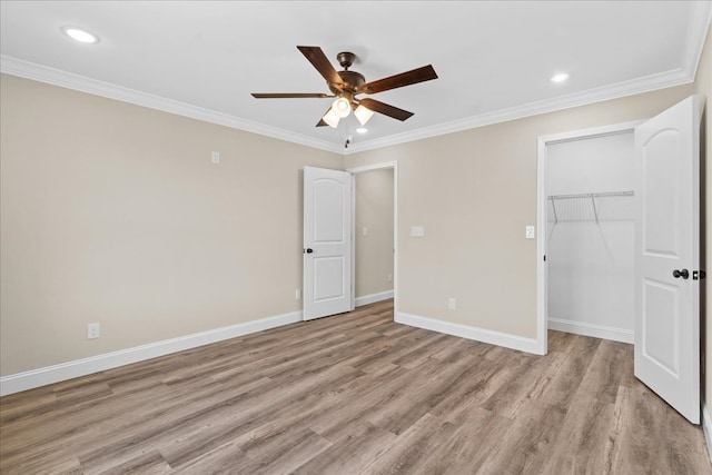 unfurnished bedroom with light wood-style floors, a closet, crown molding, and baseboards
