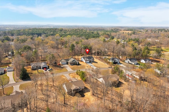 birds eye view of property featuring a forest view