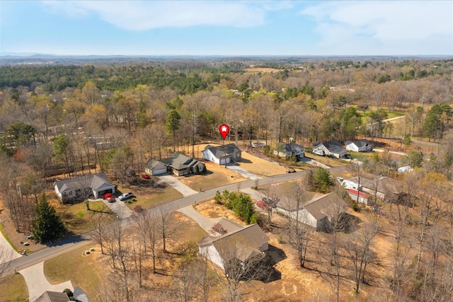 birds eye view of property featuring a wooded view