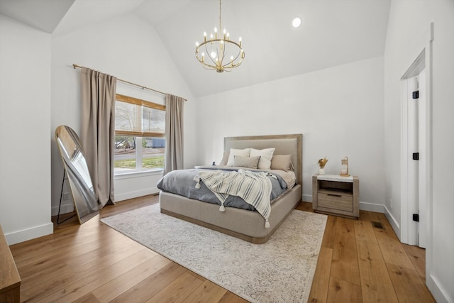bedroom featuring baseboards, light wood finished floors, and a chandelier