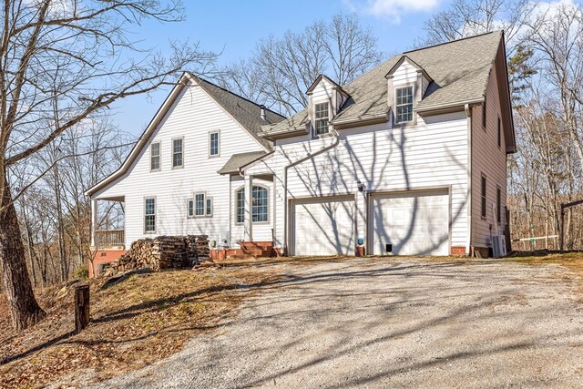 view of front of property featuring a garage and central air condition unit