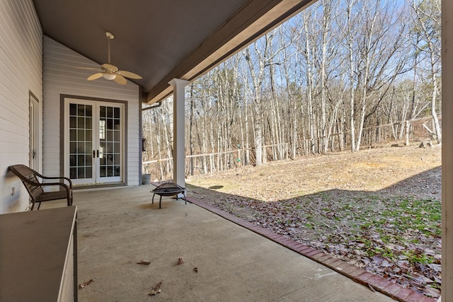 view of patio with french doors, ceiling fan, and a fire pit