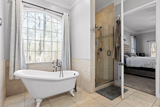 bathroom featuring independent shower and bath, ornamental molding, tile walls, and tile patterned floors