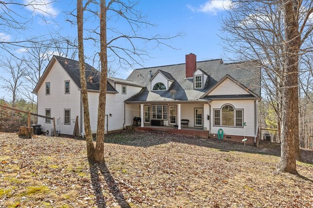 view of front of home featuring cooling unit and a patio