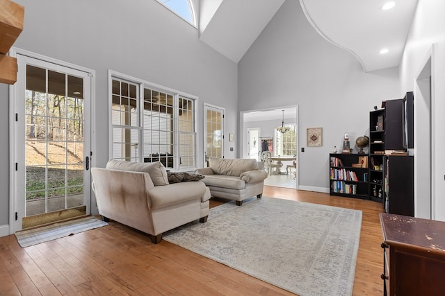 living room with hardwood / wood-style flooring and a towering ceiling