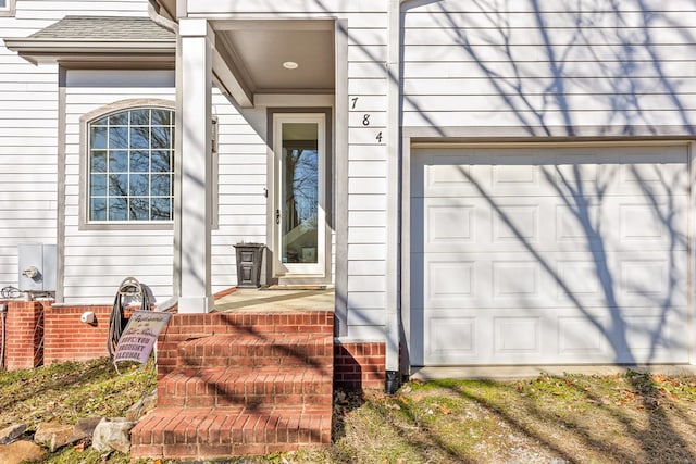 doorway to property with a garage