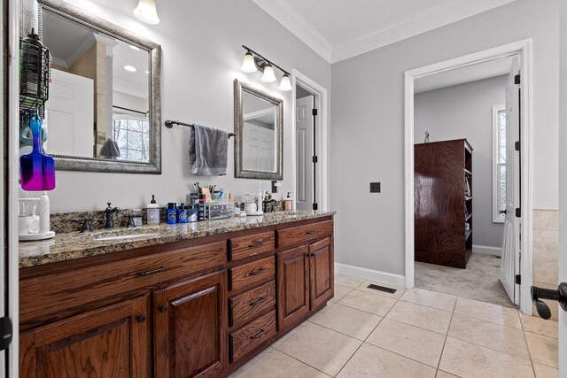 bathroom featuring tile patterned flooring, vanity, and ornamental molding