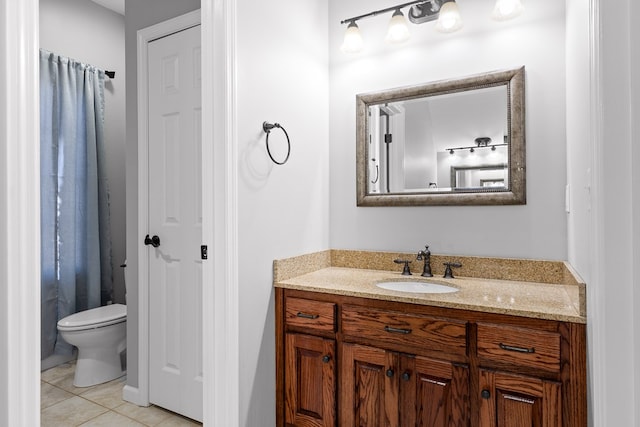 bathroom with vanity, tile patterned floors, and toilet