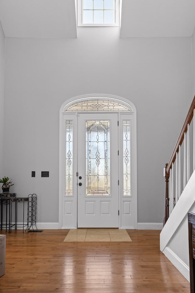 entrance foyer with a high ceiling and hardwood / wood-style floors