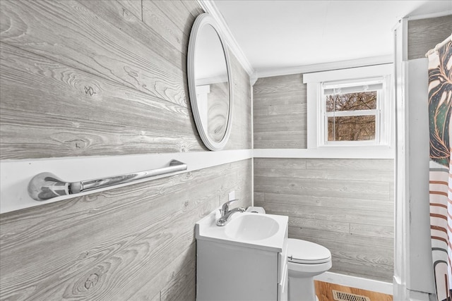 bathroom with vanity, ornamental molding, and toilet