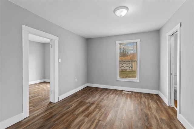 unfurnished bedroom featuring dark hardwood / wood-style floors