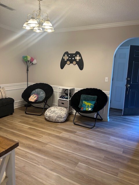 1699 Pin Oak Dr Unit 133, Dalton, GA 30721 - detailed view of arched walkways, ornamental molding, wood finished floors, a chandelier, and a textured ceiling