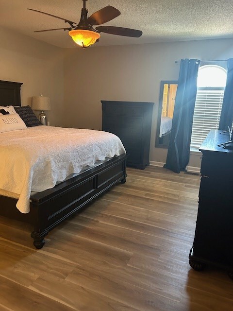 1699 Pin Oak Dr Unit 133, Dalton, GA 30721 - bedroom featuring wood finished floors, ceiling fan, and a textured ceiling