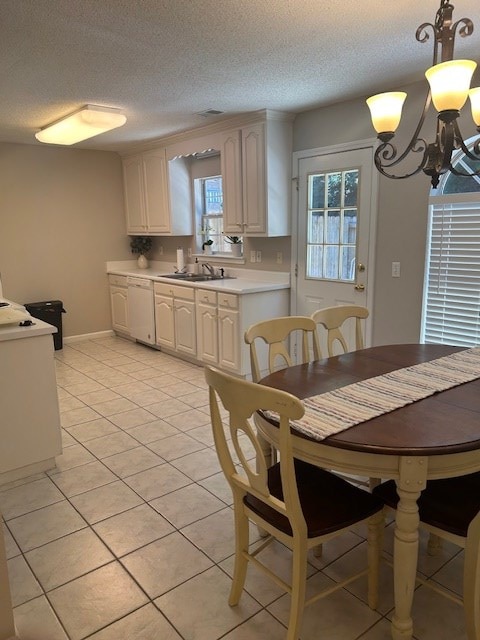 1699 Pin Oak Dr Unit 133, Dalton, GA 30721 - dining area featuring a chandelier, a textured ceiling, light tile patterned flooring, and baseboards