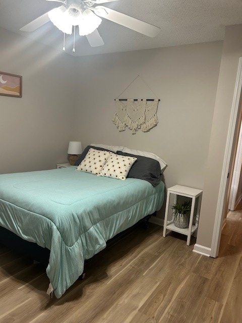 1699 Pin Oak Dr Unit 133, Dalton, GA 30721 - bedroom featuring wood finished floors, a ceiling fan, and baseboards