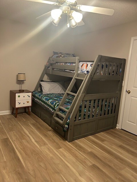 1699 Pin Oak Dr Unit 133, Dalton, GA 30721 - bedroom featuring wood finished floors, a ceiling fan, and a textured ceiling
