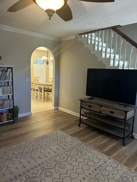 1699 Pin Oak Dr Unit 133, Dalton, GA 30721 - living area featuring arched walkways, crown molding, ceiling fan, a textured ceiling, and stairs